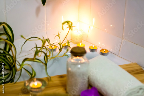 Spa-beauty salon  wellness center. Spa treatment aromatherapy for a woman s body in the bathroom with candles  oils and salt.