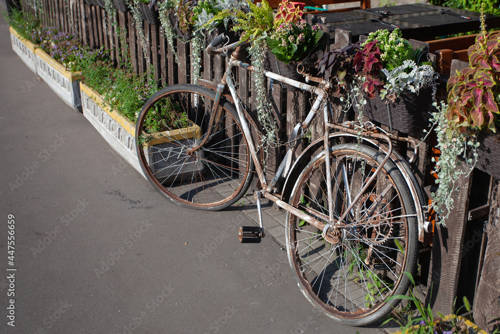 Old bike at the fence of the veranda of the summer cafe