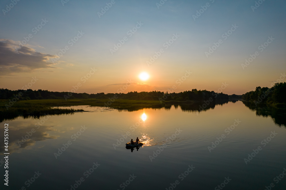 Aerial view of inflatable boat at sunset river Aerial view of inflatable boat at sunset river