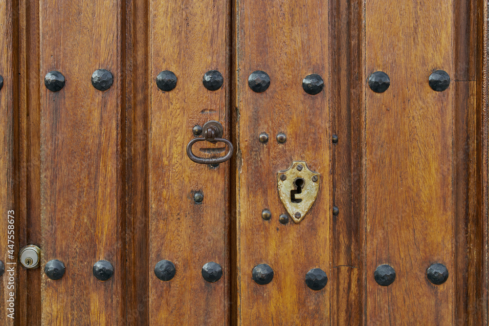 Antique wooden door with rusted hardware Antique wooden door with rusted hardware