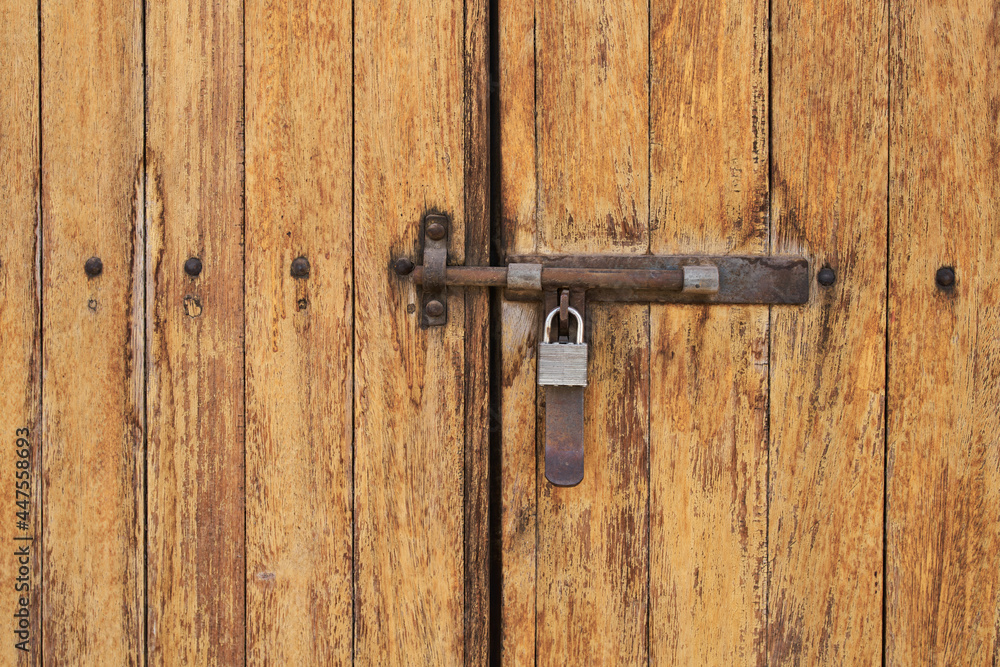 Antique wooden door with rusted hardware Antique wooden door with rusted hardware