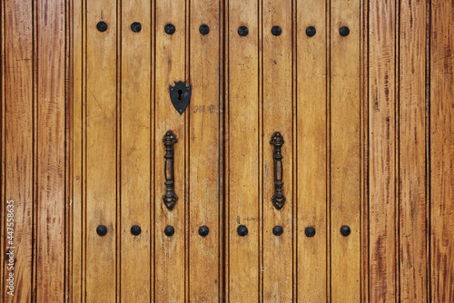 Antique wooden door with rusted hardware