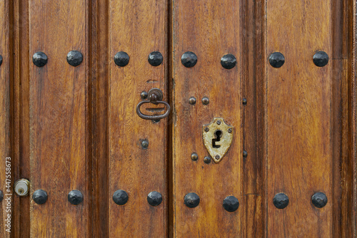Antique wooden door with rusted hardware