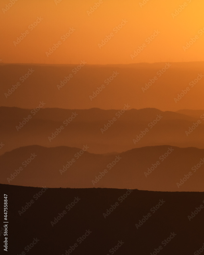 layered background of mountains at sunset