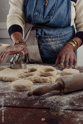 Fototapeta Naklejka Na Ścianę i Meble -  Baker cutting biscuits out of dough