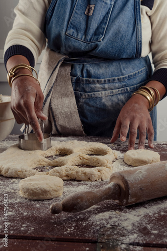 Fototapeta Naklejka Na Ścianę i Meble -  Woman chef cutting biscuits out of dough