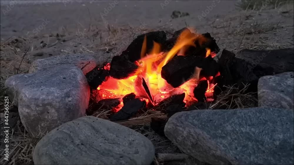 Fireplace full of coal which burning.
