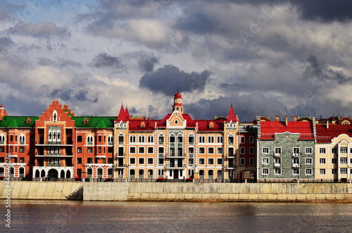 A panorama of the building on the embankment of Bruges under gloomy clouds. Russia Yoshkar Ola 01.05.2021. High quality photo