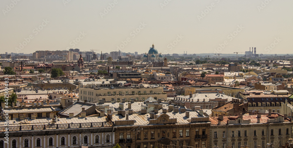 panoramic top view of the roofs of buildings in the historical part of the city and the blue sky on a sunny summer day and a copy space in Saint-Petersburg Russia