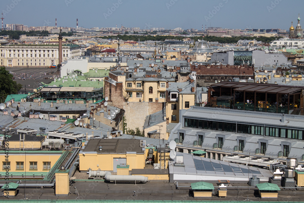 panoramic top view of the roofs of buildings in the historical part of the city and the blue sky on a sunny summer day and a copy space in Saint-Petersburg Russia