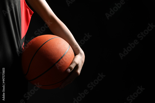 Basketball player with ball on black background, closeup. Space for text © New Africa