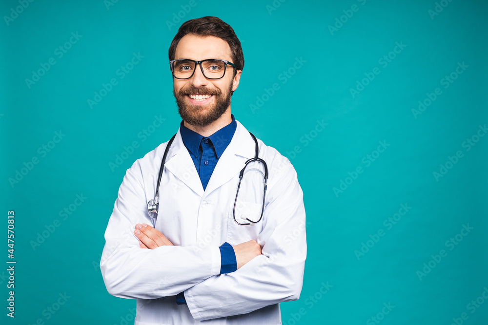 Portrait of young bearded doctor man with stethoscope over neck in medical coat standing against isolated blue background. Portrait of young bearded doctor man with stethoscope over neck in medical coat standing against isolated blue background.