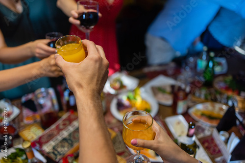 Clinking glasses with alcohol and toasting, party. photo