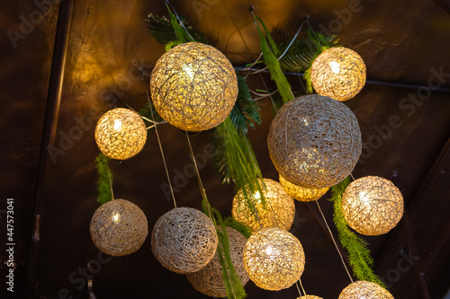 white lightning balls. modern art luxury chandelier made with balls with lamp inside every one, which conncet to beautiful flower with silver legs. Lighting ball hanging from the ceiling on background photo