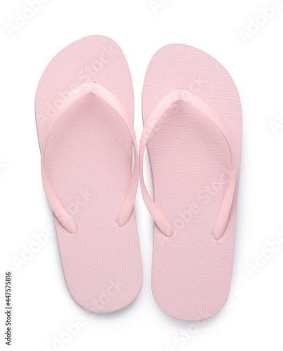 Stylish pink flip flops on white background, top view. Beach object