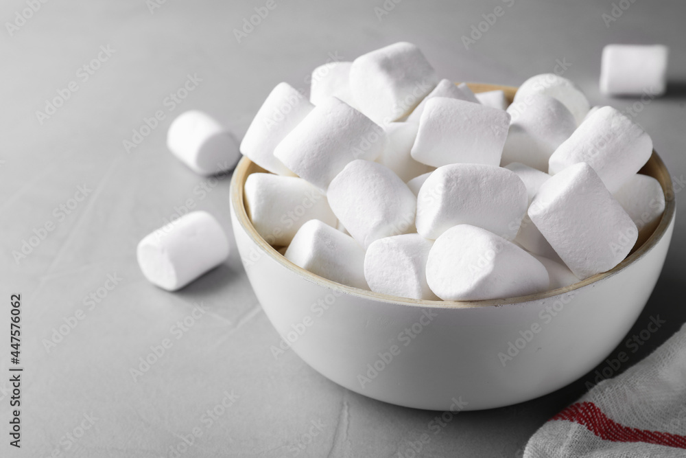 Delicious puffy marshmallows on grey table, closeup Delicious puffy marshmallows on grey table, closeup