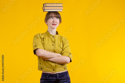 Young woman with books on h...