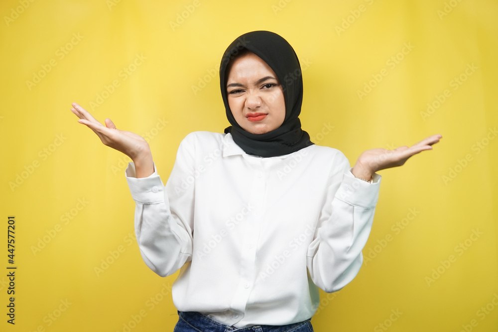 Beautiful asian young muslim woman with i don't know sign expression, isolated on yellow background Beautiful asian young muslim woman with i don't know sign expression, isolated on yellow background