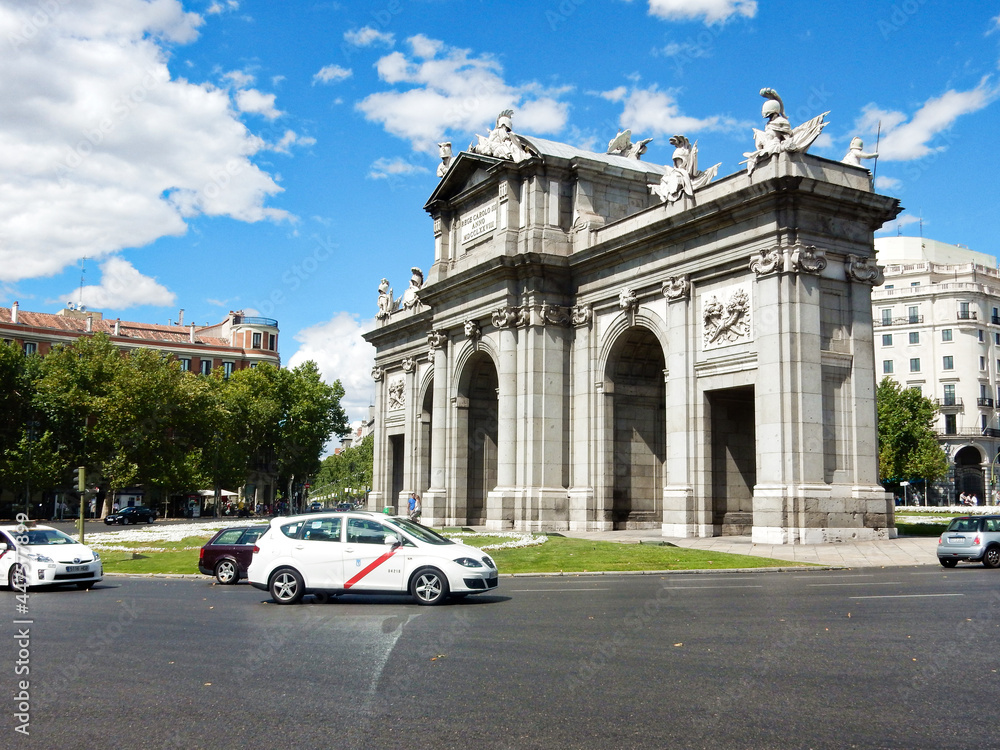 Fototapeta premium Public Monument La Puerta De Alcala arch, Madrid, Spain Bounded by a Traffic Circle