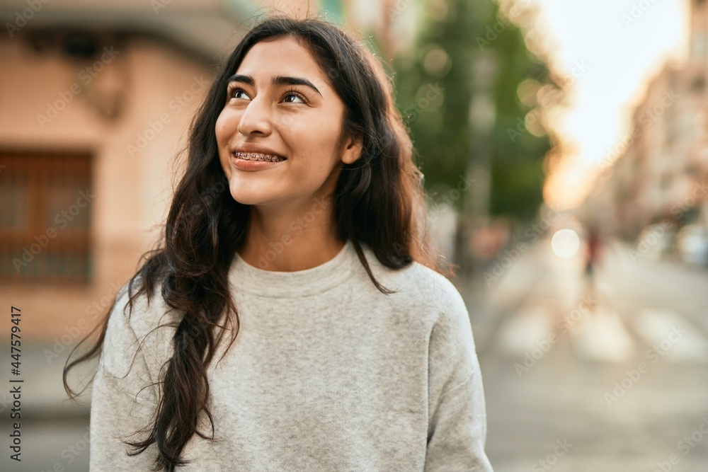 Young middle east girl smiling happy standing at the city.