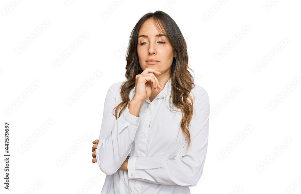 Young brunette woman wearing casual clothes with hand on chin thinking about question, pensive expression. smiling with thoughtful face. doubt concept. Young brunette woman wearing casual clothes with hand on chin thinking about question, pensive expression. smiling with thoughtful face. doubt concept.
