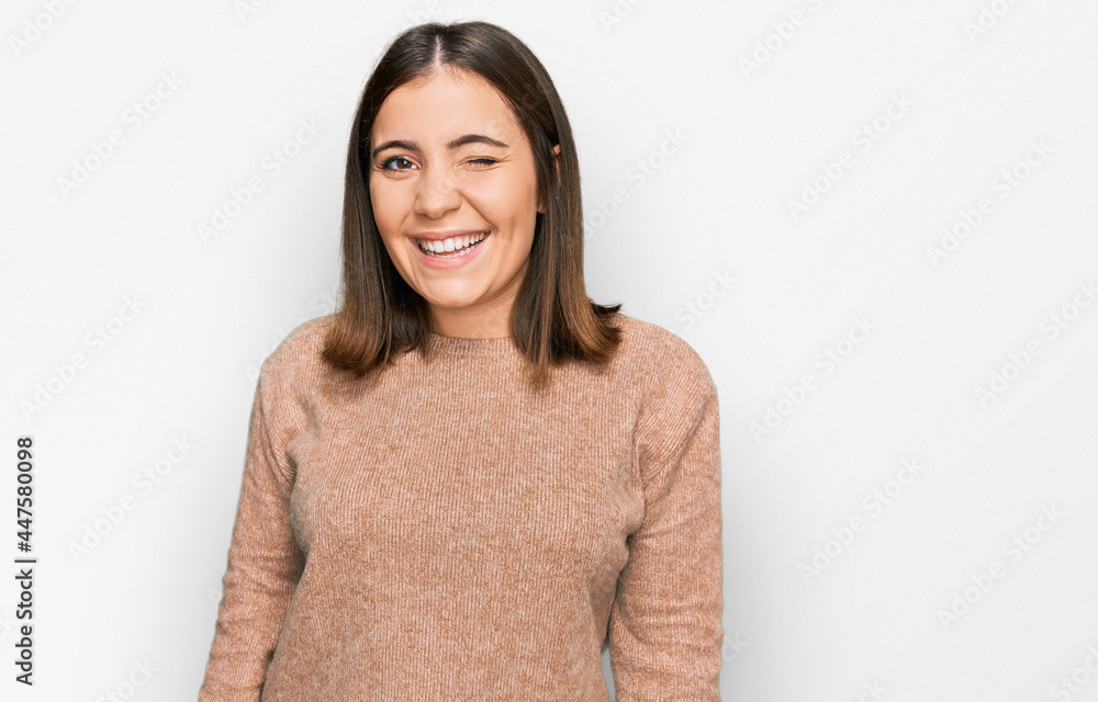 Young beautiful woman wearing casual clothes winking looking at the camera with sexy expression, cheerful and happy face. Young beautiful woman wearing casual clothes winking looking at the camera with sexy expression, cheerful and happy face.