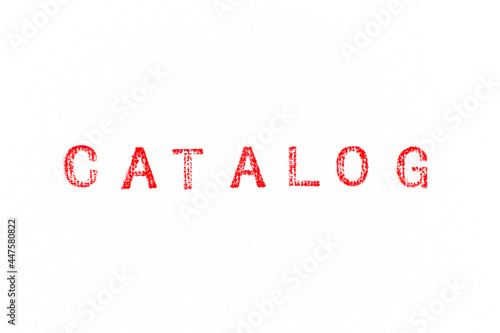 Red color rubber stamp in word catalog on white paper background photo