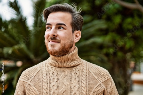 Young caucasian man smiling happy standing at the city.