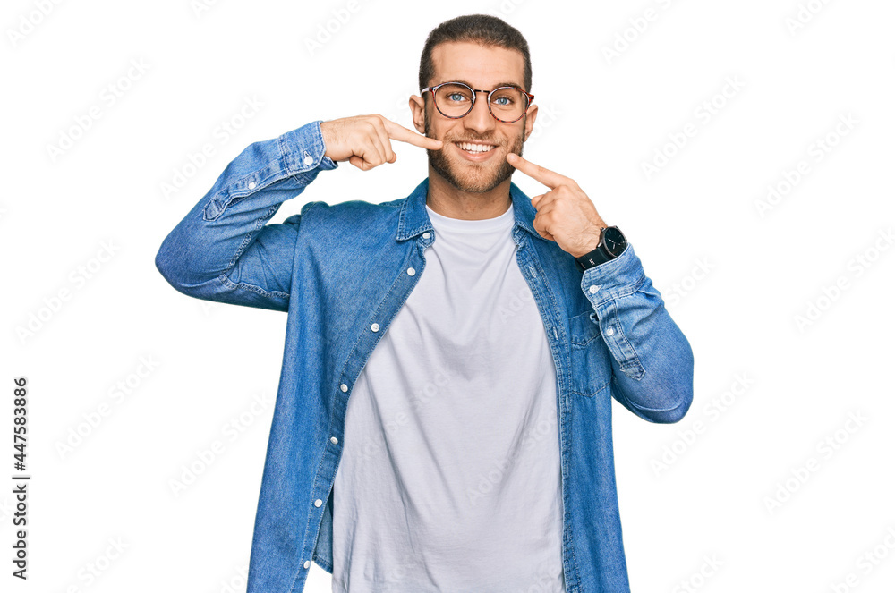 Young caucasian man wearing casual clothes smiling cheerful showing and pointing with fingers teeth and mouth. dental health concept. Young caucasian man wearing casual clothes smiling cheerful showing and pointing with fingers teeth and mouth. dental health concept.