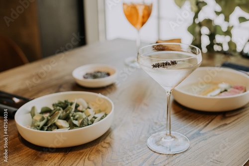 A table topped with plates of food on a plate and cocktail