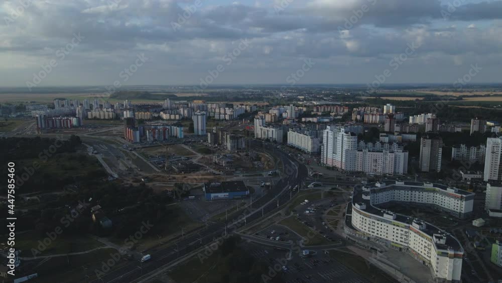 Flight over the city block at dawn. In the rays of the rising sun, multistory buildings and a green area are visible. Aerial photography. Flight over the city block at dawn. In the rays of the rising sun, multistory buildings and a green area are visible. Aerial photography.