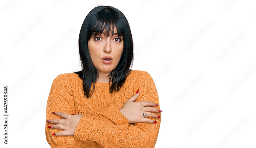 Young hispanic woman wearing casual clothes shaking and freezing for winter cold with sad and shock expression on face Young hispanic woman wearing casual clothes shaking and freezing for winter cold with sad and shock expression on face