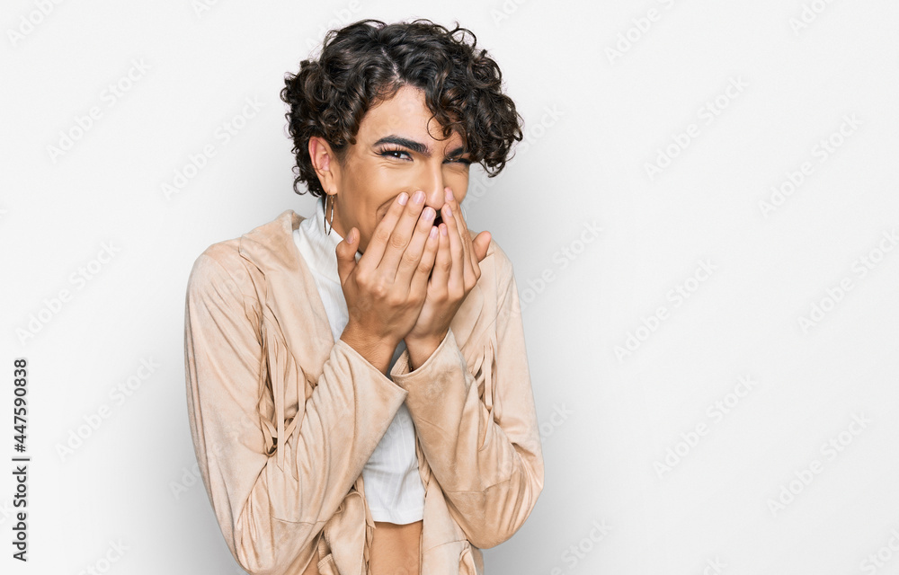 Handsome man wearing make up and woman clothes laughing and embarrassed giggle covering mouth with hands, gossip and scandal concept Handsome man wearing make up and woman clothes laughing and embarrassed giggle covering mouth with hands, gossip and scandal concept