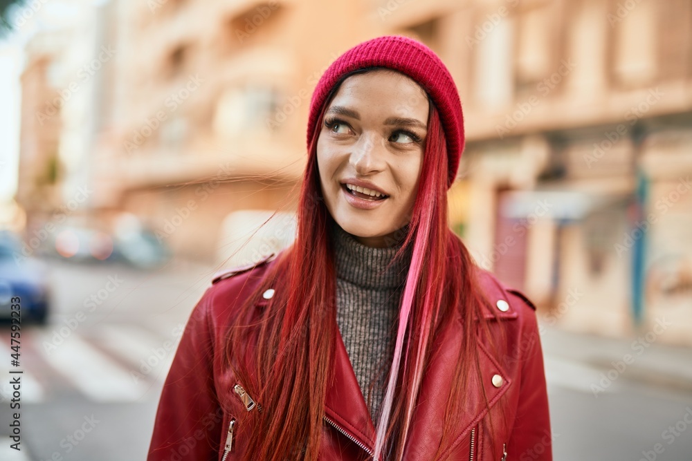 Young caucasian girl smiling happy standing at the city.