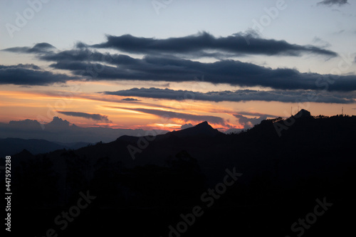 Beautiful orange and blue sunset with a huge mountain rage silhouette 