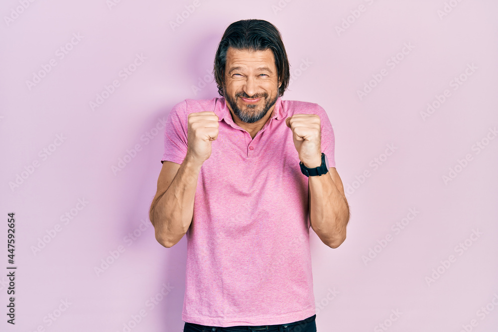 Middle age caucasian man wearing casual white t shirt excited for success with arms raised and eyes closed celebrating victory smiling. winner concept. Middle age caucasian man wearing casual white t shirt excited for success with arms raised and eyes closed celebrating victory smiling. winner concept.