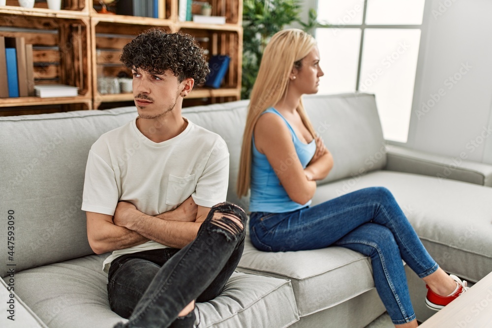 Fototapeta premium Young couple angry sitting on the sofa in silence at home.