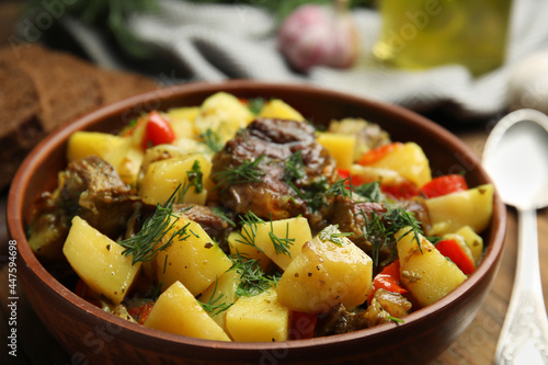 Tasty cooked dish with potatoes in earthenware, closeup