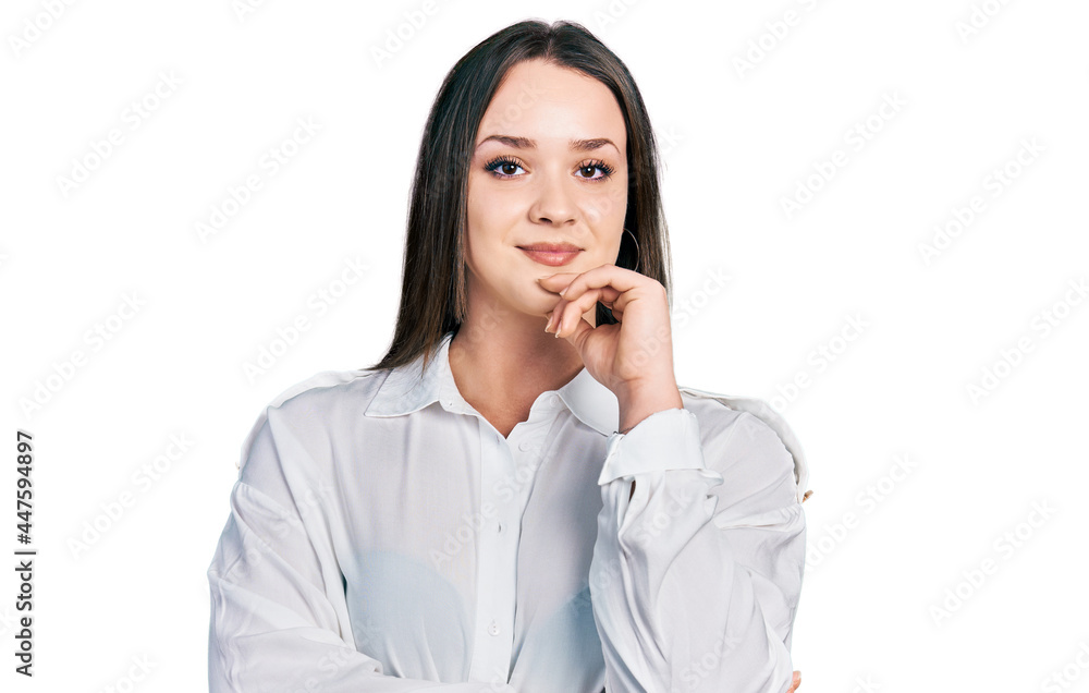 Young hispanic woman wearing casual clothes smiling looking confident at the camera with crossed arms and hand on chin. thinking positive. Young hispanic woman wearing casual clothes smiling looking confident at the camera with crossed arms and hand on chin. thinking positive.