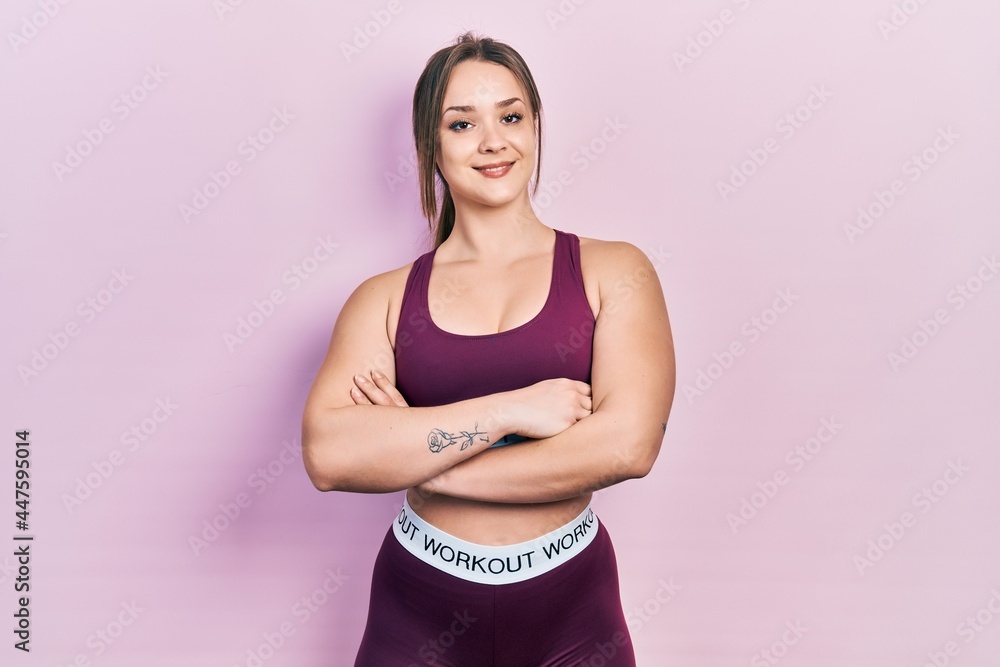 Young hispanic girl wearing sportswear happy face smiling with crossed arms looking at the camera. positive person.