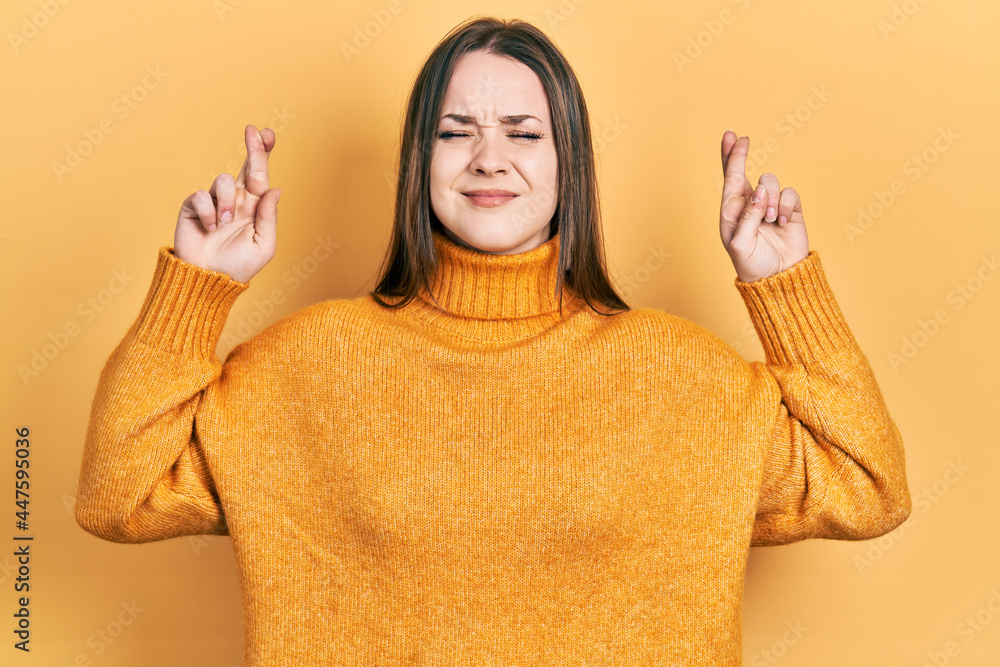 Young hispanic girl wearing casual clothes gesturing finger crossed smiling with hope and eyes closed. luck and superstitious concept. Young hispanic girl wearing casual clothes gesturing finger crossed smiling with hope and eyes closed. luck and superstitious concept.
