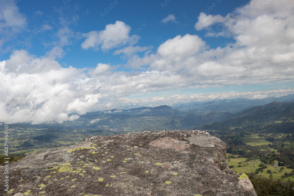 Colombian valley countryside and eastern mountains viewed from an ancient monolith called 
