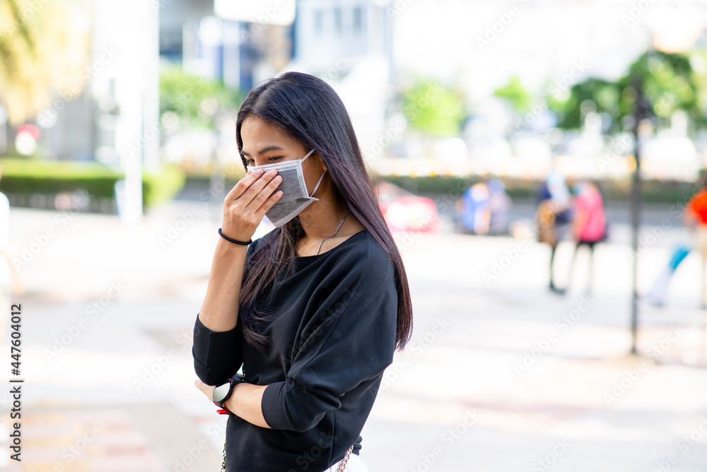 Face of Asian woman wearing a face mask for protection virus or pollution with outdoor city background. coronavirus protect. Sick concept and other protect such as Air, Dirt, Fever. Health concept.