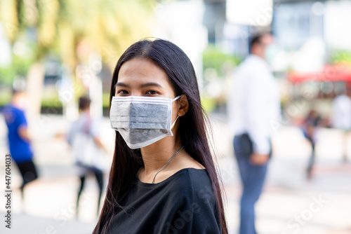 Face of Asian woman wearing a face mask for protection virus or pollution with outdoor city background. coronavirus protect. Sick concept and other protect such as Air, Dirt, Fever. Health concept.