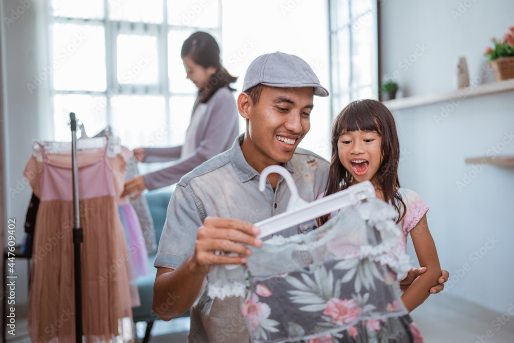 happy asian family shopping in the clothing store together happy asian family shopping in the clothing store together