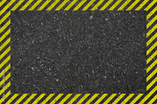 Asphalt texture with hazard sign. Yellow hazard pattern on asphalt background