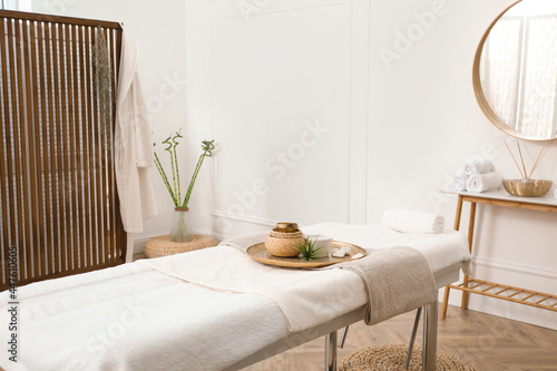 Schilderij op canvas Stylish room interior with massage table in spa salon
