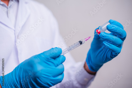 Doctor holding tube with Coronavirus vaccine and syringe. Healthcare And Medical concept.
