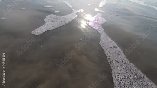 person walking on the beach with sunrise