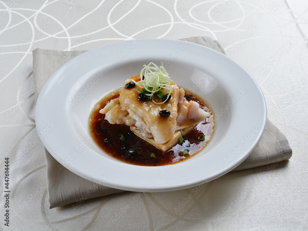 braised grouper fish seafood with tofu in black bean thick soy sauce seafood in white background asian halal menu braised grouper fish seafood with tofu in black bean thick soy sauce seafood in white background asian halal menu